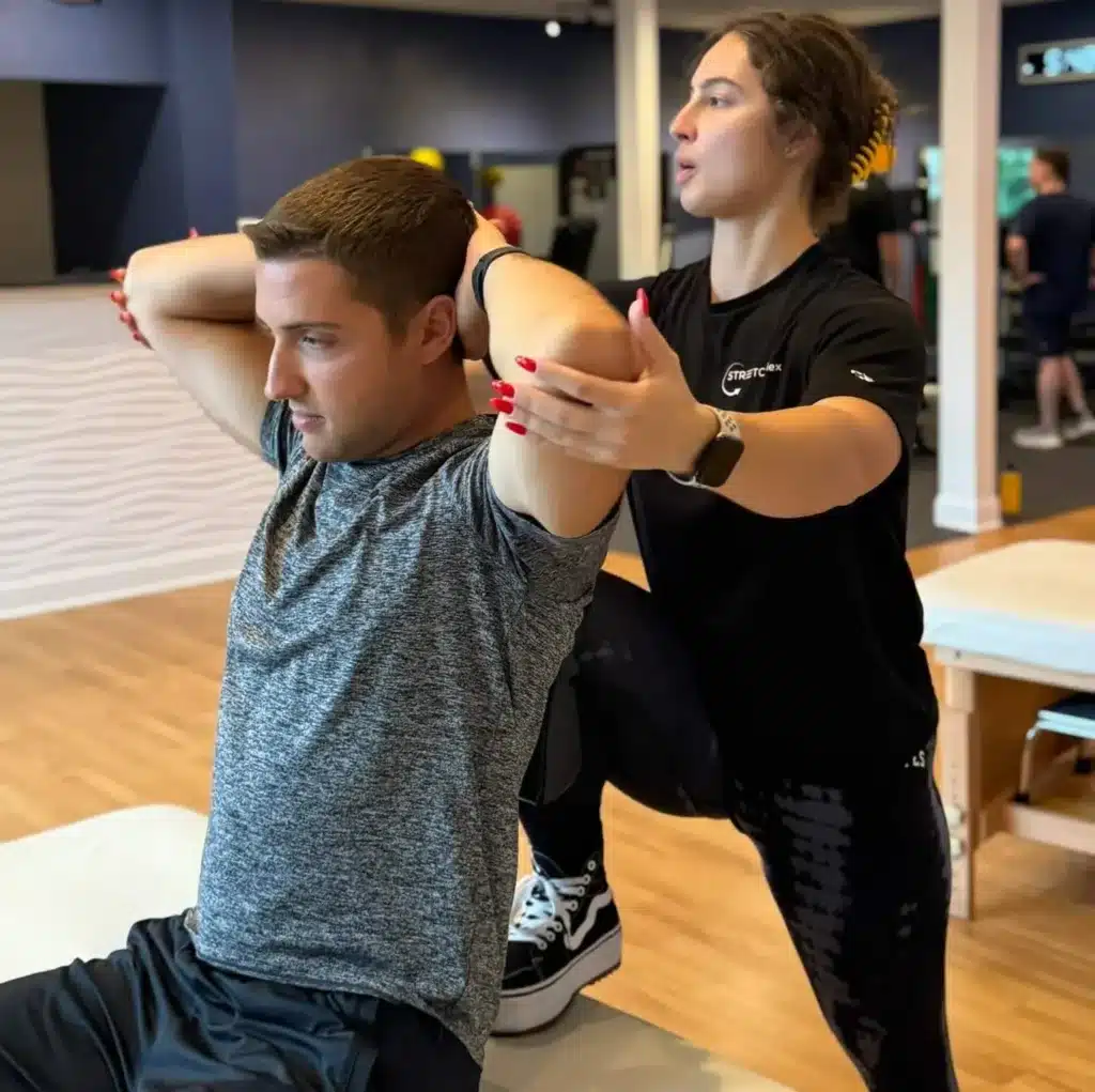 Client stretching session for flexibility and muscle recovery